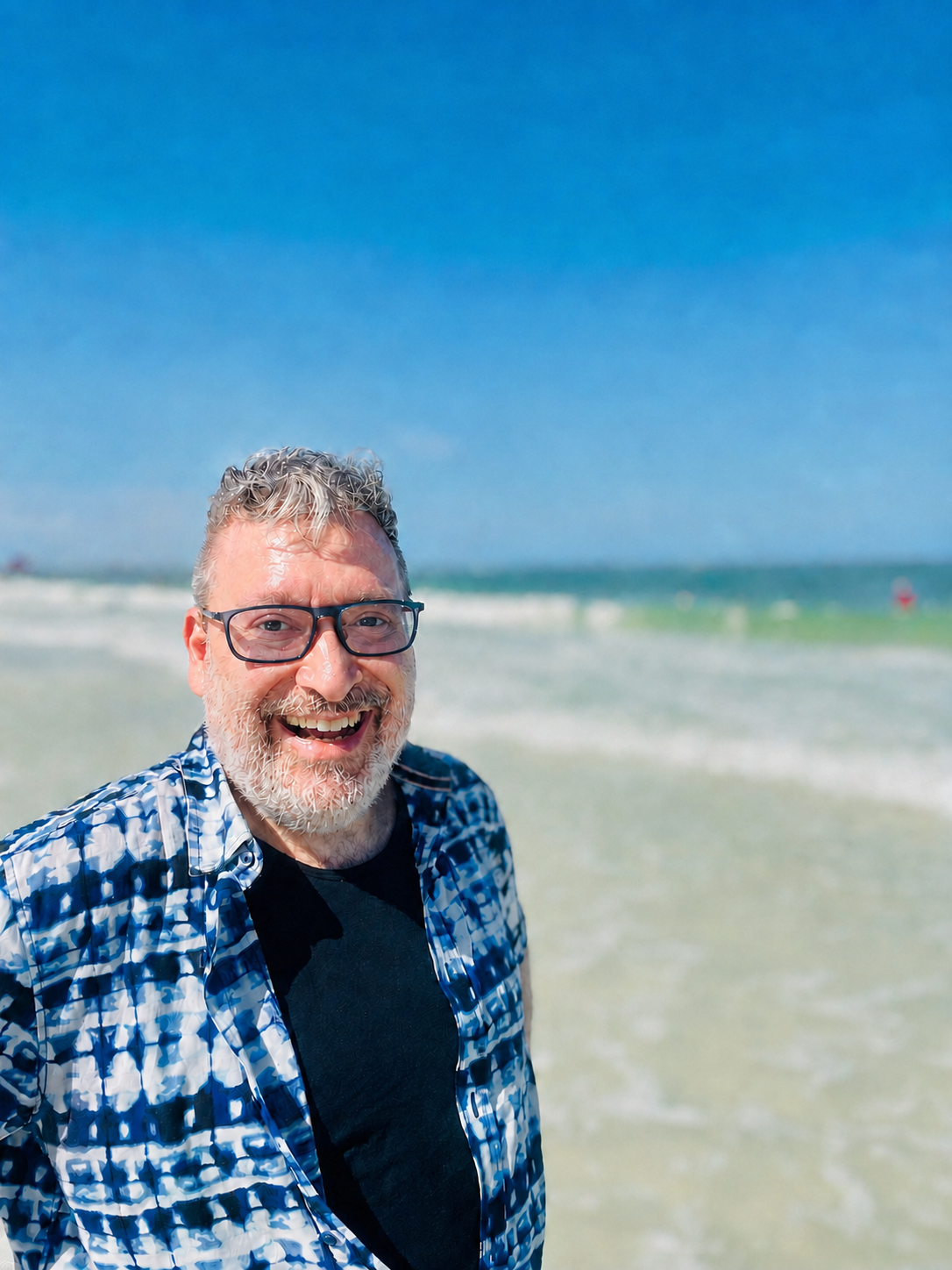 Manuel Simons smiling on a beach